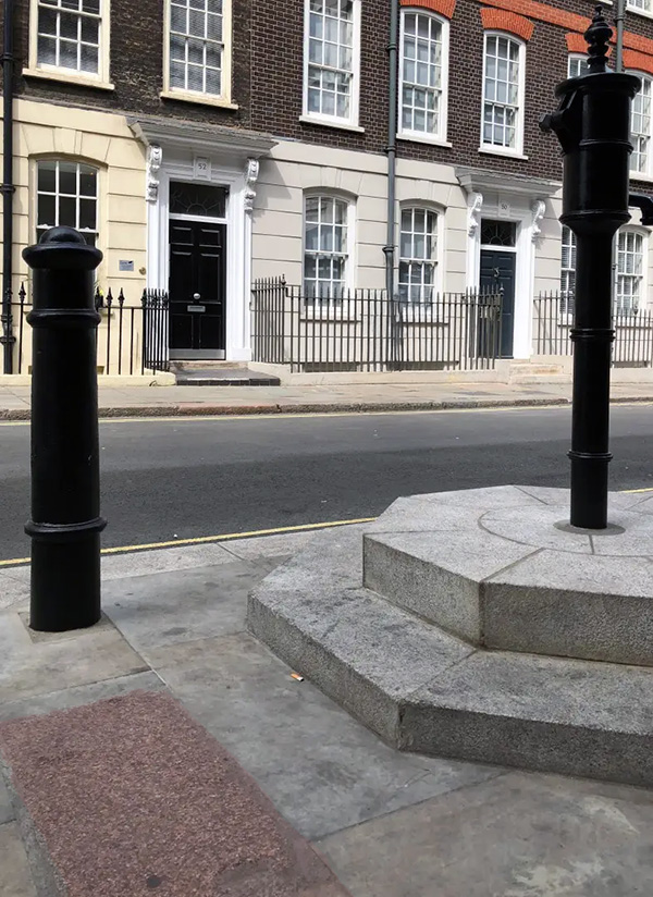 pink curbstone next to moved Broad Street pump