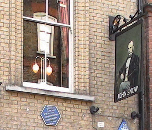 side of pub with sign and plaque